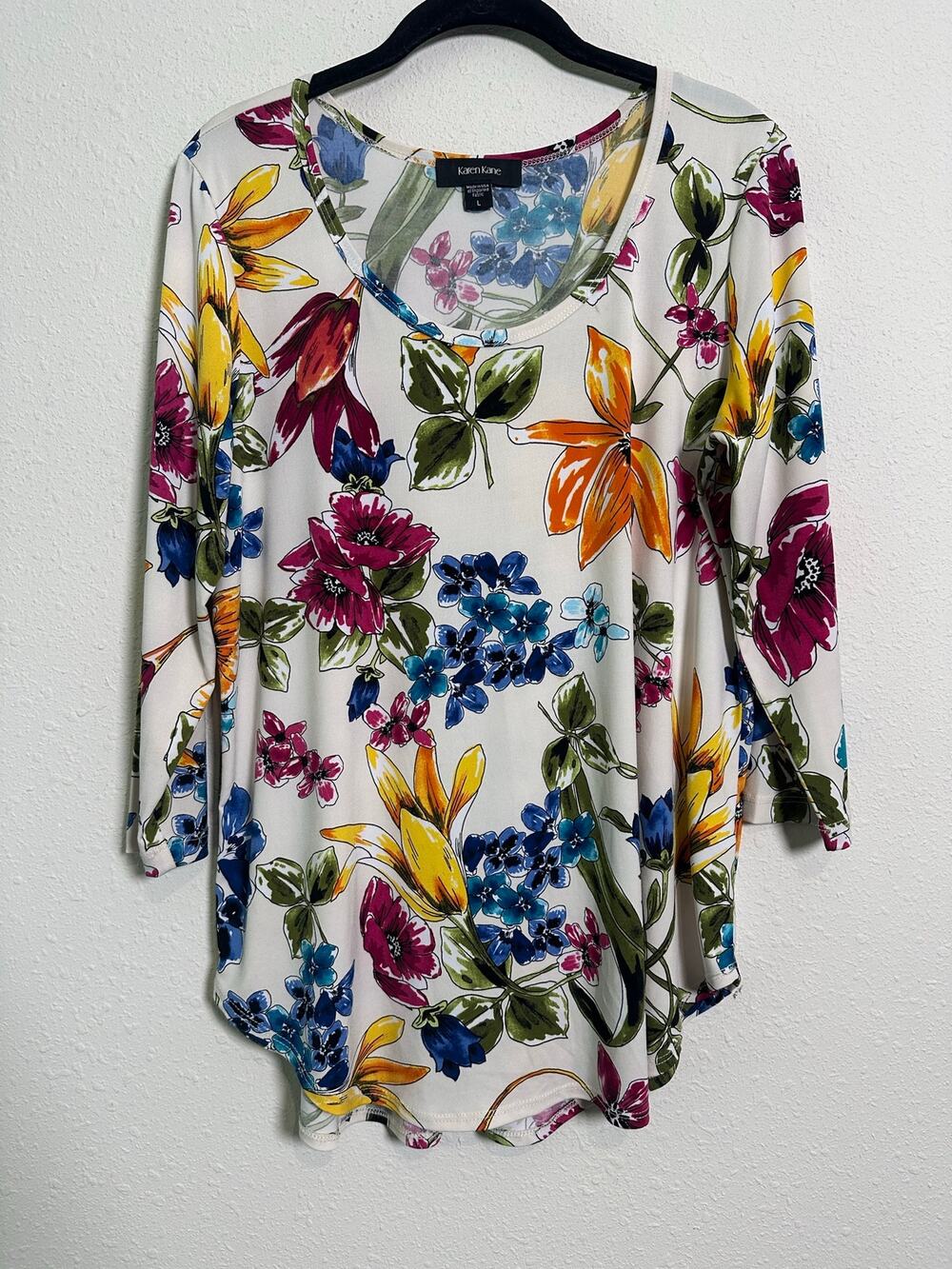 Karen Kane ivory multicolor floral print scoop neck three-quarter curved hem.